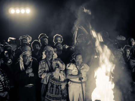 Tikal, Guatemala Dec 2012 - People surround a large fire at the Mayan new year celebrationsのeditorial素材