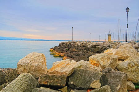 View of lighthouse of Desenzano in the province of Brescia, in Lombardy, Italy, on the southwestern shore of Lake Garda.の写真素材