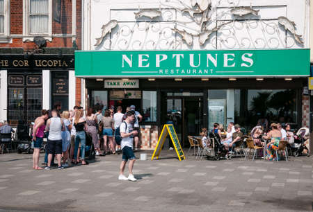 Daytrippers queue for chips on a hot day.