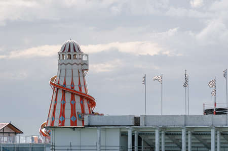 A traditional lighthouse helter skeltor on Clacton pier set againts a summer blue sky.の写真素材
