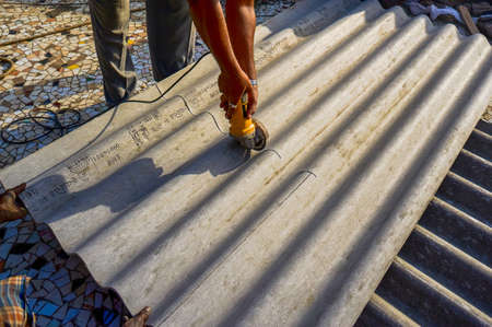 04 Mar 2009 Man working with Power Cutter on Asbestos roof sheet Lokgram Kalyan Maharashtra Indiaの写真素材