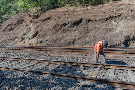 29-apr-2011-central railway Rail track maintenance worker at work khandala western ghats maharashtra INDIAのeditorial素材
