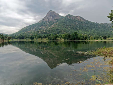 29 Oct 2019 Calm water in Lake Against Sky and hills of Aravalli range North Gujarat Indiaの写真素材