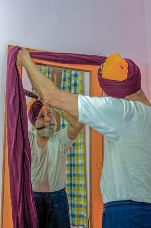 12 22 2010 Selective focus in axen Sikh Person Tying his Turban as part of his ritual Bidar...
