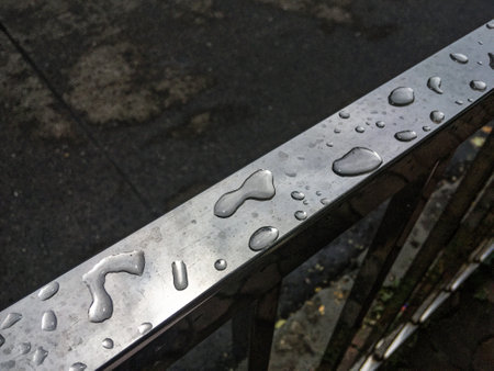 08 22 2022 Rain water drops on roadside steel Railing Charniroad Mumbai Maharashtra India.の写真素材
