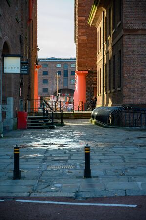 The Tate Liverpool seen through a narrow opening next to the Dock Traffic Office at the Albert Dock in Liverpool.の写真素材