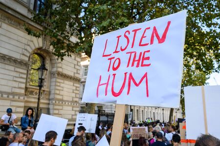 LONDON - SEPTEMBER 20, 2019: Homemade Climate Change protest placard at an Extinction Rebellion march with protesters in the backgroundのeditorial素材