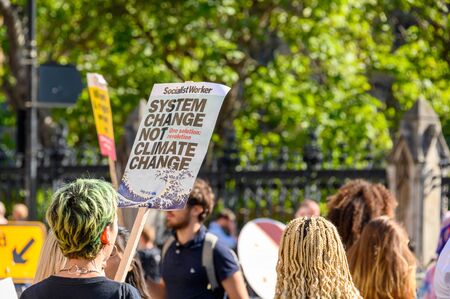 LONDON - SEPTEMBER 20, 2019: Climate change protester holding a protest placard at an Extinction Rebellion marchのeditorial素材