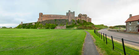 Panoramic view of Bamburgh Castle viewed from village green and cricket groundのeditorial素材