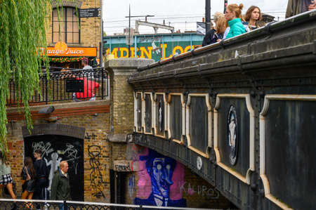 LONDON - SEPTEMBER 30, 2019: Bridges, shoppers and graffiti at Camden Lockのeditorial素材
