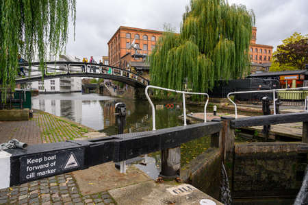 LONDON - SEPTEMBER 30, 2019: The top gate at Camden Lock with iron foot bridge in the background