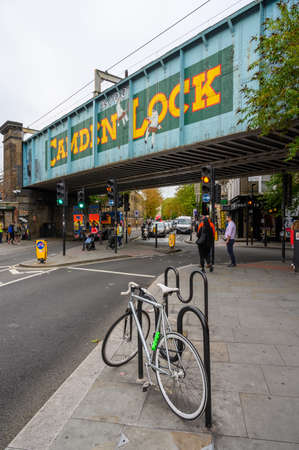 LONDON - SEPTEMBER 30, 2019: Tall shot of the famous Camden Lock bridge on Camden High Street with the painted sign clearly visible and a bike in the foregroundのeditorial素材