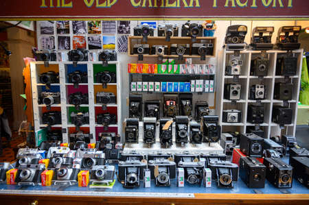 LONDON - SEPTEMBER 30, 2019: An antique camera stall displaying a range of old cameras and film...