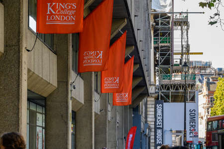 LONDON - SEPTEMBER 23, 2019: King's College London flags hanging above the KCL entrance to The Strand Buildingのeditorial素材