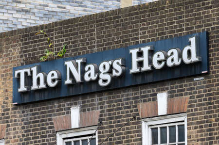 LONDON - SEPTEMBER 23, 2019: Sign above strip club entrance on Whitechapel Road, Whitechapel, Londonのeditorial素材