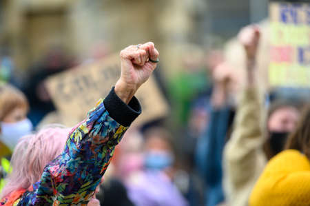 Richmond, North Yorkshire, UK - June 14, 2020: A elderly woman's hand held high in salute at a Black...