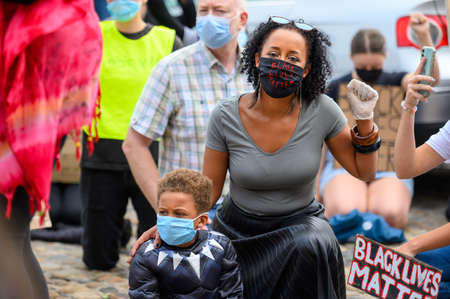 Richmond, North Yorkshire, UK - June 14, 2020: A woman wears a Black Lives Matter PPE Face Mask and...