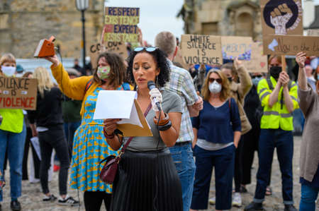 Richmond, North Yorkshire, UK - June 14, 2020: Protesters holding placards listen to a female...