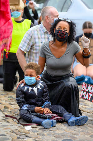 Richmond, North Yorkshire, UK - June 14, 2020: A powerful BAME woman wears a Black Lives Matter PPE...
