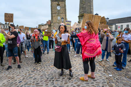 Richmond, North Yorkshire, UK - June 14, 2020: A protester comforting a speaker at an anti-racism, Black Lives Matter protest in the Marketplace in Richmond, North Yorkshireのeditorial素材