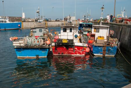 Boats moored in an English harbour on a sunny day.