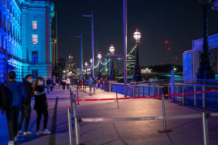 LONDON - SEPTEMBER 14, 2021: Colourfully lit night scene on The Queen's Walk, Southbank between The London Eye and County Hallのeditorial素材