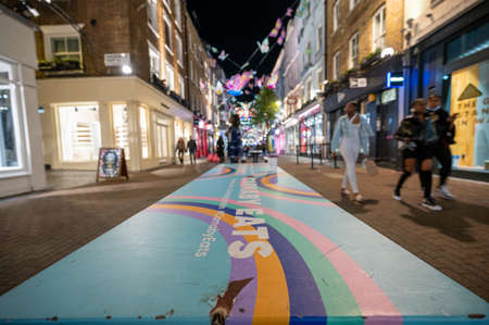 LONDON - NOVEMBER 1, 2021: Colourful table with Carnaby Street Christmas lights out of focus in the backgroundのeditorial素材