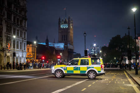 LONDON - NOVEMBER 5, 2021: Paramedic 4x4 waits with protesters and Houses of Parliament in background at The Million Mask Marchのeditorial素材