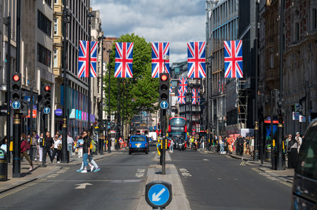 LONDON - May 18, 2022: Union Jack flags hanging above busy street for London Jubilee celebrationのeditorial素材