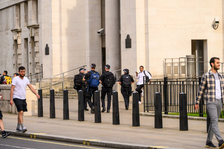 LONDON - May 18, 2022: Armed Police with backpacks outside the Ministry of Defence, London