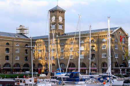 LONDON - November 2, 2020: Ivory House, St Katherine's Dock with dappled late afternoon golden sunlight and moored boats in the foregroundのeditorial素材