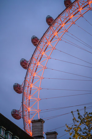 LONDON - April 22, 2023: Witness the symbolic illumination of the London Eye in orange for Stephen Lawrence Day, creating a powerful evening tribute.のeditorial素材
