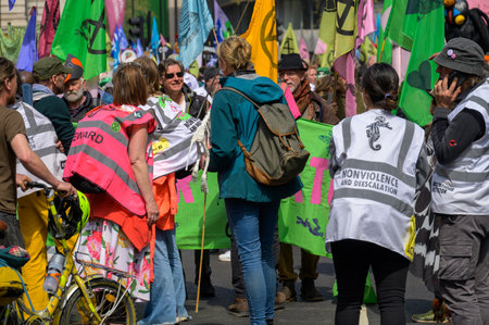 LONDON - April 22, 2023: A riot of colors: Extinction Rebellion protesters at the XR protest rally in London, with a vibrant backdrop of colourful XR flags, unite for climate action.のeditorial素材