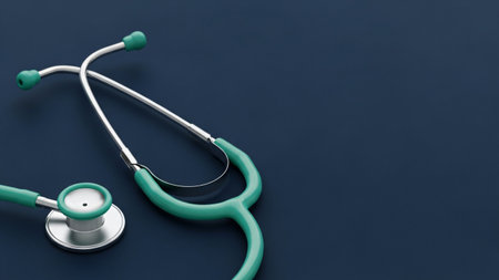 A green stethoscope is placed on a dark blue surface, creating a clean and professional medical image.の写真素材
