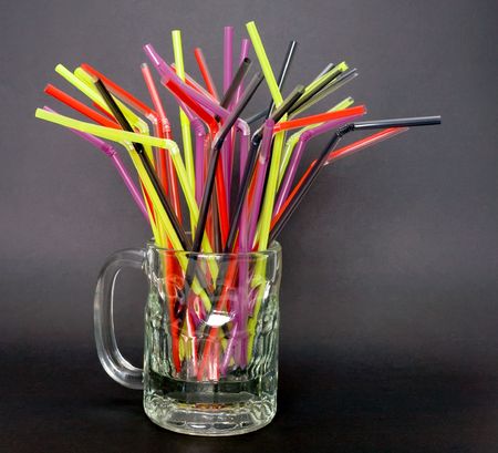 A bunch of colorful straws in a mugの写真素材