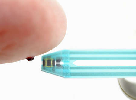 Finger with blood drop and glucose test strip