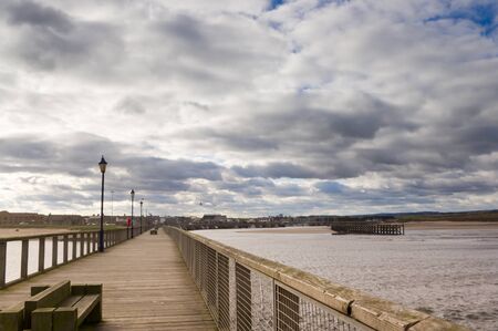 Amble harbour and village viewed from the pierの写真素材
