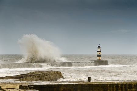 Crashing waves over Seaham Harbour north pier in a rough seaの写真素材