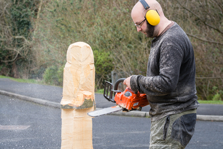 Chainsaw sculptor / The making of an owl sculpture by a chainsaw sculptor here in the early stagesの写真素材