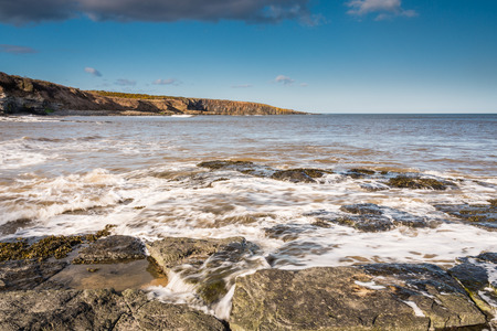 Incoming Tide at Cullernose Point  Incoming tide flowing over the rocky shoreline at Cullernose Point on the Northumberland coastの写真素材