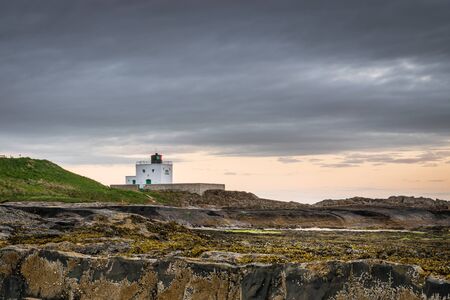 Blackrocks Point Lighthouse  Viewed from the rocks is Blackrocks Point Lighthouse just north of Bamburgh in Northumberlandの写真素材