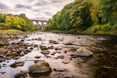 River South Tyne and Lambley Viaduct  The Lambley Railway Viaduct was built in 1852 and towers over the River South Tyne in Northumberland. There are nine arches which support a deck 32 metres above the riverの写真素材