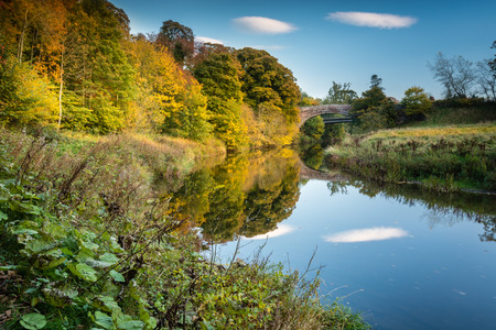 River Till and Twizel Bridge - Built in 1511 the medieval Twizel Bridge played a major part in the build up to the Battle of Flodden. It crosses the River Till in the border country of Northumberlandの写真素材