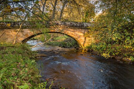 River Wansbeck below Kirkwhelpington Bridge, which rises in the Northumberland hills above Sweethope Lough, then journeys towards the North Sea near Newbigginの写真素材