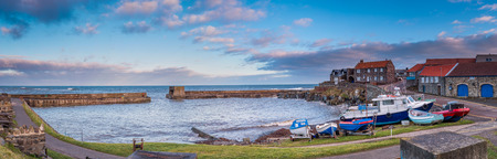 Panorama of Craster Harbour, Craster is a small fishing village on the Northumberland coast, with a small harbour and views to the ruins of Dunstanburgh Castleのeditorial素材