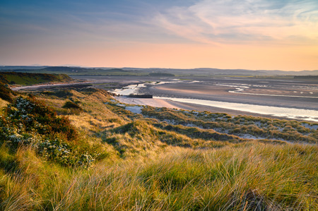 Mud Flats and Dunes at Budle Bay, seen here at low tide they are part of Lindisfarne Nature reserve on Northumberland's AONB coastlineの写真素材
