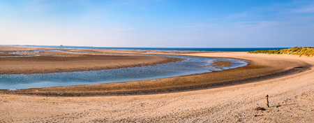 Budle Bay Panorama, the mud flats at low tide are part of Lindisfarne Nature reserve on Northumberland's AONB coastlineの写真素材
