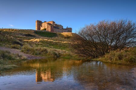 Floodwater in Bamburgh Beach Dunes, which are dominated by the imposing medieval castle and located within Northumberland Coast Area of Outstanding Natural Beautyの写真素材