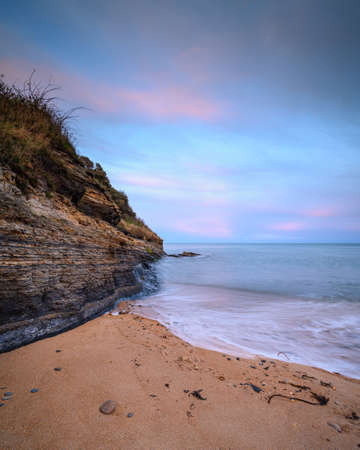 Cliff and Beach at Iron Scars, on the shoreline at Howick on the Northumberland coast AONB, where there are several sandy covesの写真素材