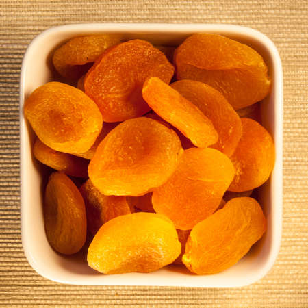 dried apricots,  a low glycemic index food, in a square bowl, viewed from aboveの写真素材
